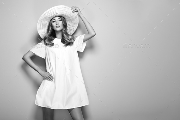 Blonde young woman in elegant white dress - Stock Photo - Images