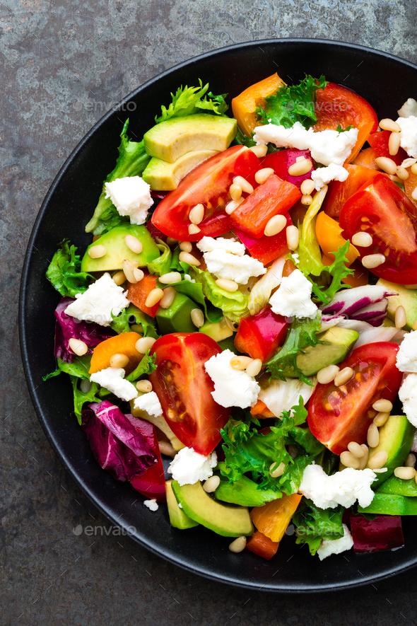 Vegetable dish, salad with avocado, pepper, tomato, italian mix, fresh lettuce, feta cheese - Stock Photo - Images