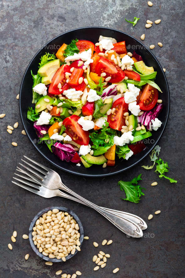Vegetable dish, salad with avocado, pepper, tomato, italian mix, fresh lettuce, feta cheese - Stock Photo - Images
