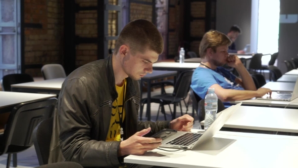People Work on Laptops at Coworking