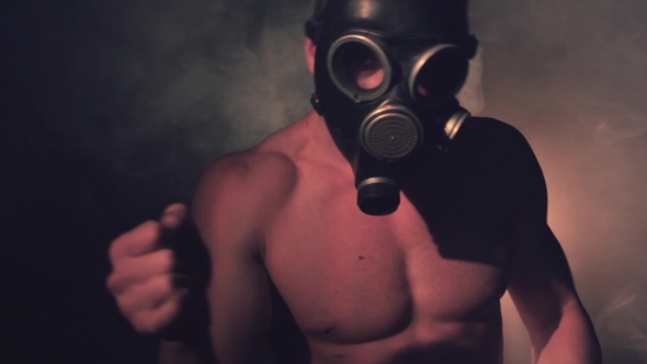 Man Wearing a Gasmask Dances in Smoke alt