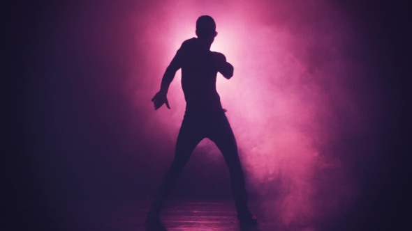 Silhouette of a Man Dance in Smoke