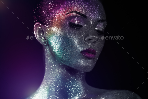 Portrait of beautiful woman with sparkles on her face - Stock Photo - Images