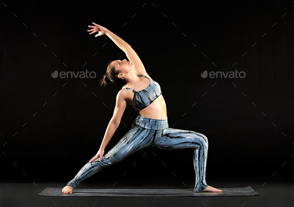 Young woman demonstrating a reverse warrior pose - Stock Photo - Images