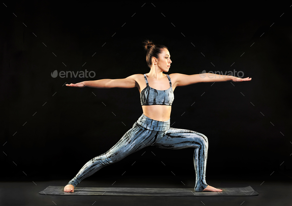 Woman demonstrating the warrior 2 pose in yoga - Stock Photo - Images