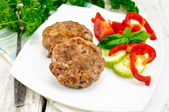 Cutlets stuffed with basil on light board - Stock Photo - Images