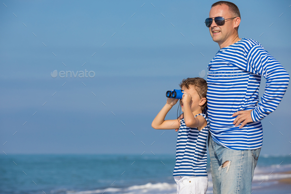 Father and son playing on the beach at the day time. Concept of - Stock Photo - Images