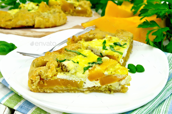 Pie of pumpkin and cheese in white plate on napkin - Stock Photo - Images