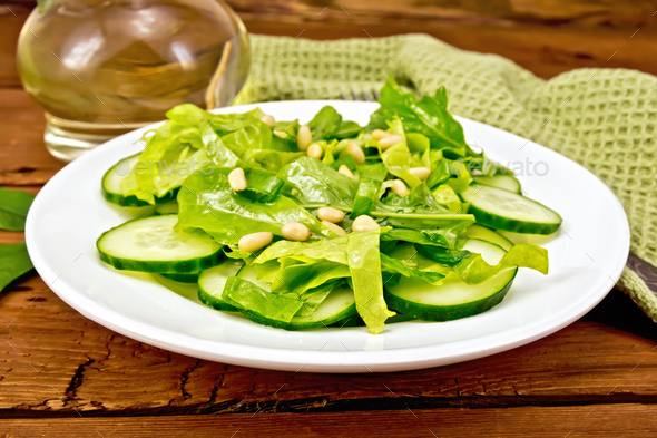 Salad from spinach and cucumber with napkin on board - Stock Photo - Images
