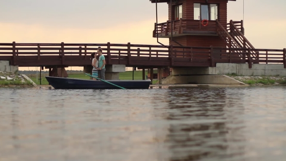 A Loving Couple Is Floating on a Boat