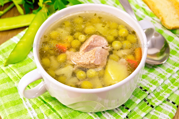Soup from green peas with meat on napkin - Stock Photo - Images