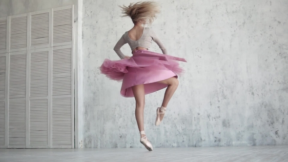 Ballerina Is Spinning on Her Toe in a Pink Dress. Young Girl Dances Classical Ballet. alt