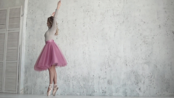 Ballerina Is Spinning on Her Toe in a Pink Dress. Young Girl Dances Classical Ballet alt