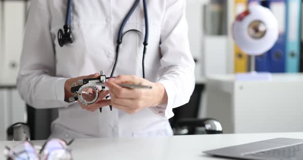 Doctor Ophthalmologist Explaining How to Use Special Glasses to Check and Correct Vision Closeup alt