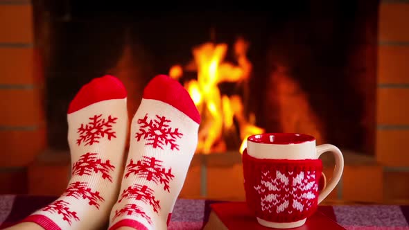 Female in Christmas Socks near Fireplace