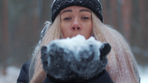 Girl Blowing Snow in the Air