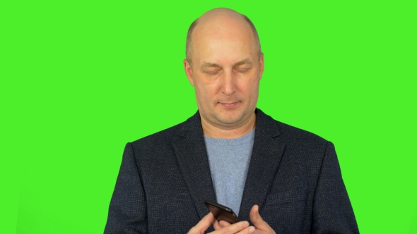 Caucasian Man Make Call with Smart Phone. Man Talks By Cell Phone. Using Phone Man in Blue Suit alt