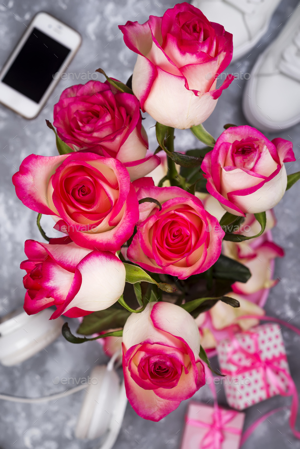 composed of the roses and mobile phone on the back of a blurry background - Stock Photo - Images