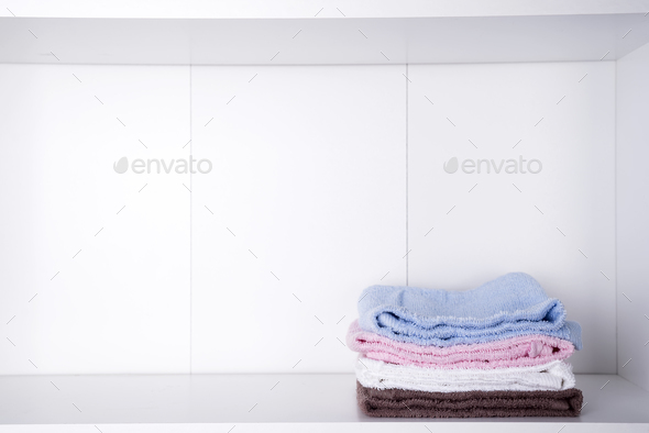 Stack of colorful bath towels on light background - Stock Photo - Images