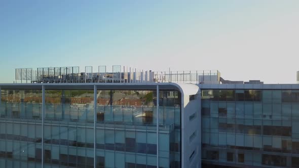 Aerial revealing La Plata River and Buenos Aires Ecological reserve behind a modern building alt