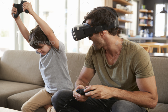Father And Son Play Computer Game Using Virtual Reality Headset Stock Photo by monkeybusiness