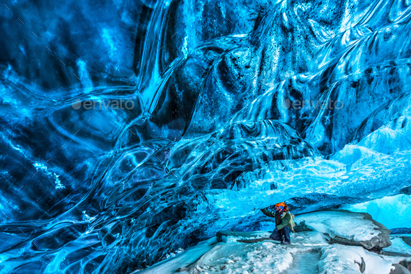 Traveler in the ice cave - Stock Photo - Images