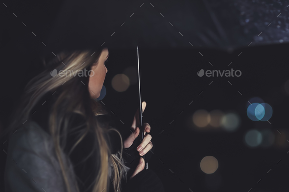 Female outdoors in rainy night - Stock Photo - Images