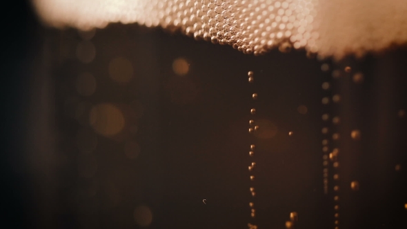 Bubbles Movement Inside a Large Glass Mug with Fresh Beer