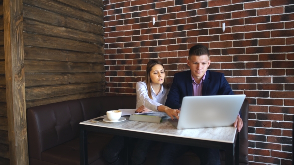 Two Young Businessman Having a Successful Meeting at Restaurant. alt