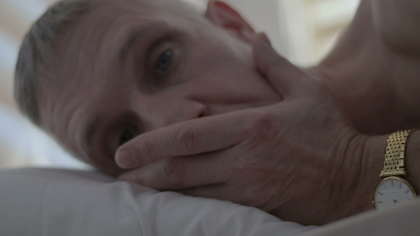The Face of an Upset Man Who Lies in Bed After an Unsuccessful Sex alt