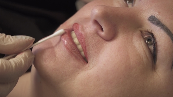 Beautician, Specialist of Permanent Make-up Is Applying Local Anesthetic Before the Lips Permanent