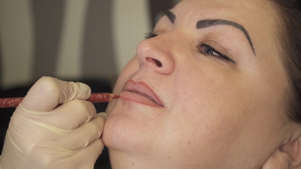 Shot. Professional Specialist of Permanent Make-up Applying Lips Before the Procedure. Beauty