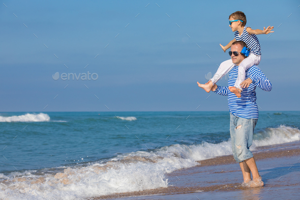 Father and son playing on the beach at the day time. Concept of - Stock Photo - Images