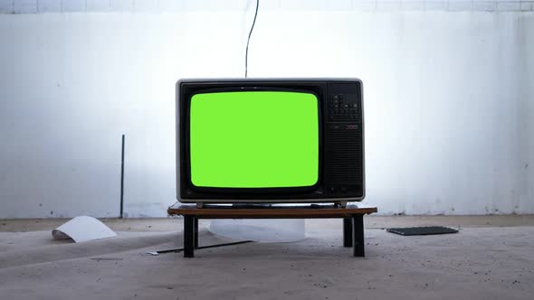 Old Tv Green Screen in the Middle of a room. Aesthetics of the 80s.