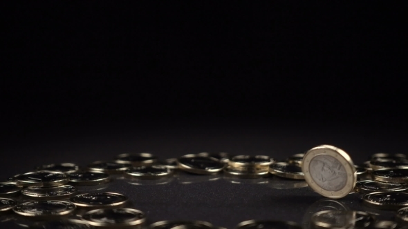One Euro Coin Spinning on a Black Background alt