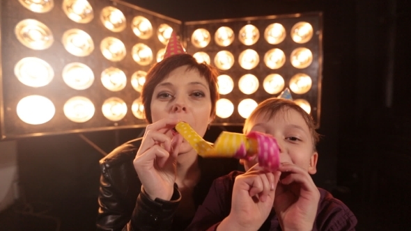 Mom and Her Son with a Party in a Party Hat. Celebrate a Birthday. The Exaltation of Emotion