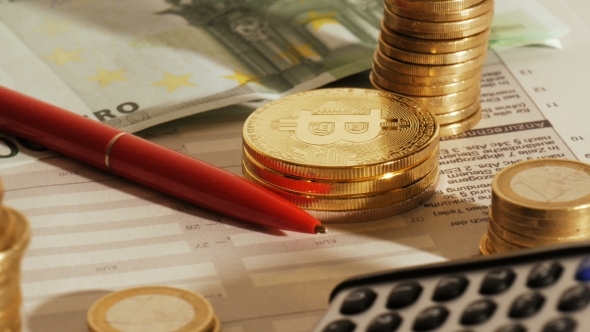 Bitcoins on an Office Table While Filling Out the Tax Declaration