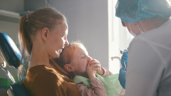 Little Girl with Mommy in Dentist Chair - Child Is Playing alt