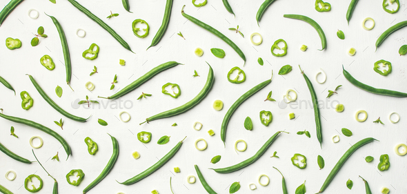Flat-lay of fresh green beans over white background, wide composition - Stock Photo - Images
