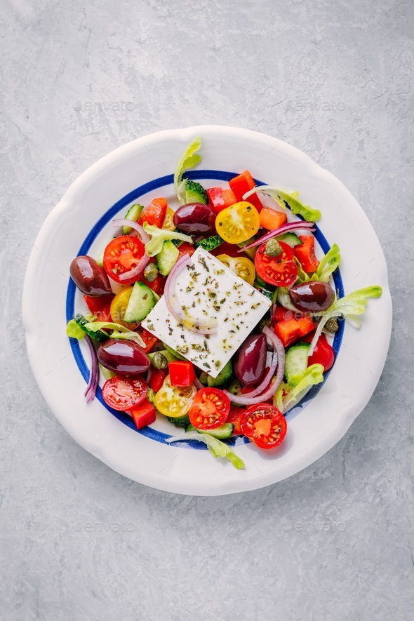 Delicious Greek salad with feta cheese, olives, tomatoes, cucumbers