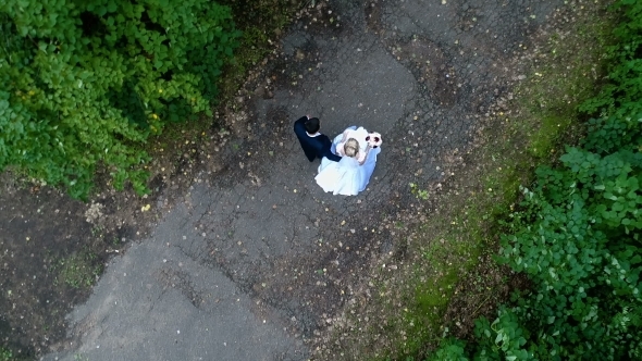 The Bride and Groom Walk Along the Alley