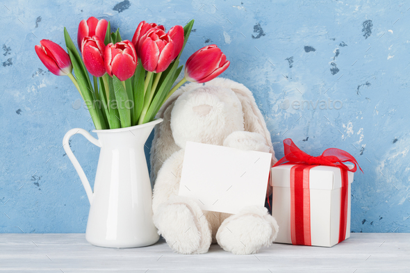 Red tulip flowers and easter rabbit toy - Stock Photo - Images