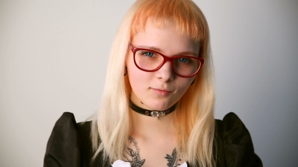 Modern Youth Calm Portrait of a Girl of Unusual Appearance with Glasses