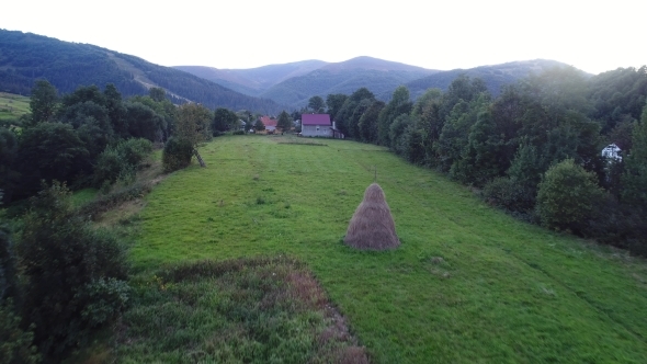 A Flight Over a Field in a Small Village in the Mountains