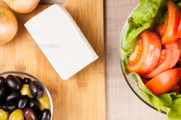 Top view of table with feta cheese on wooden board - Stock Photo - Images
