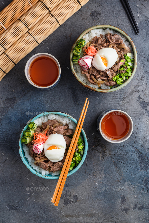 Two beef bowls or gyudon with egg and onion top view Stock Photo by fazeful