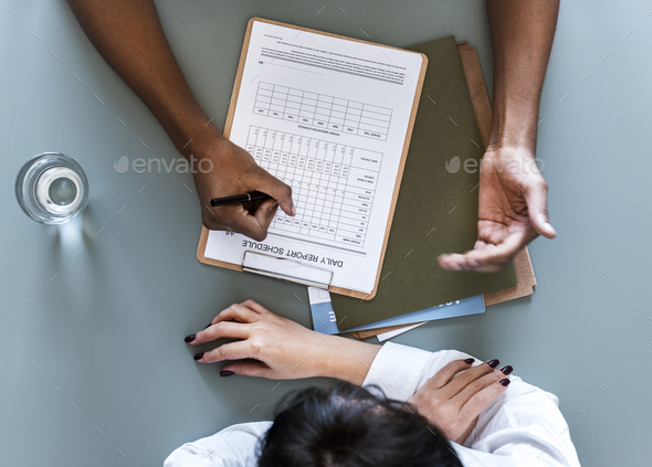 Aerial view of doctor writing patient daily report checklist - Stock Photo - Images