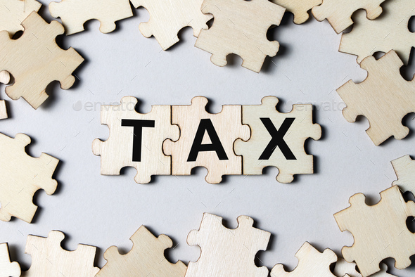 Puzzle pieces with word tax - Stock Photo - Images