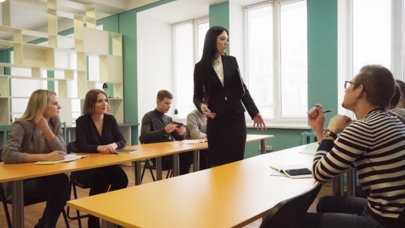 Students and a Female Teacher During a Lesson in a Classroom