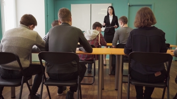 Woman Teacher Talking To Students During a Lesson at University